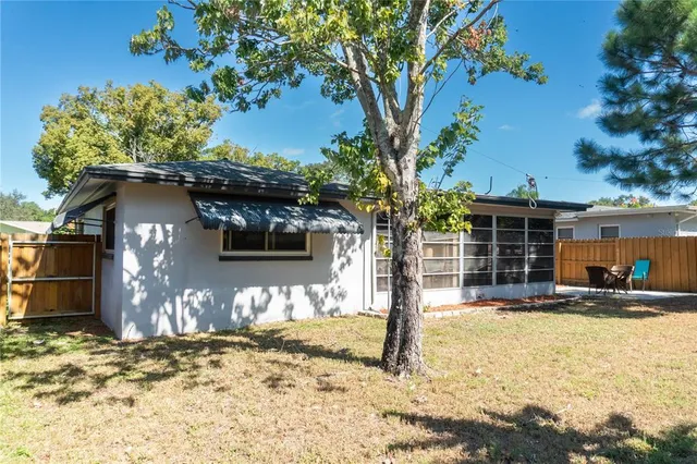 a front view of a house with a yard covered with snow