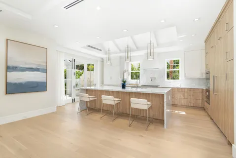 a large kitchen with a table and chairs in it