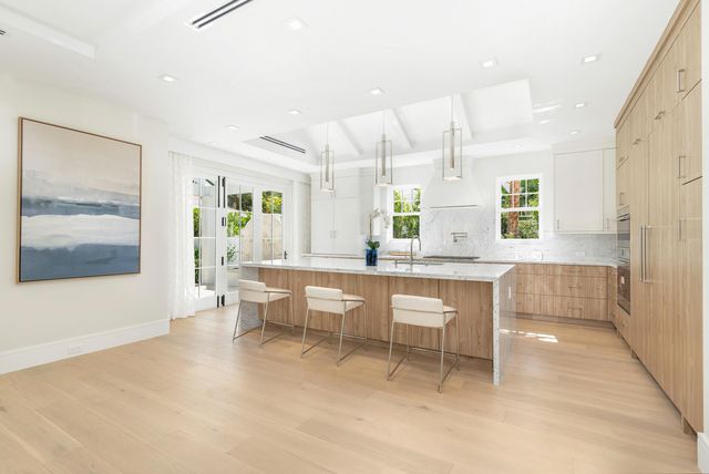 a large kitchen with a table and chairs in it