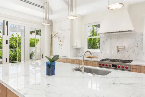 a spacious bedroom with a large bed and a chandelier