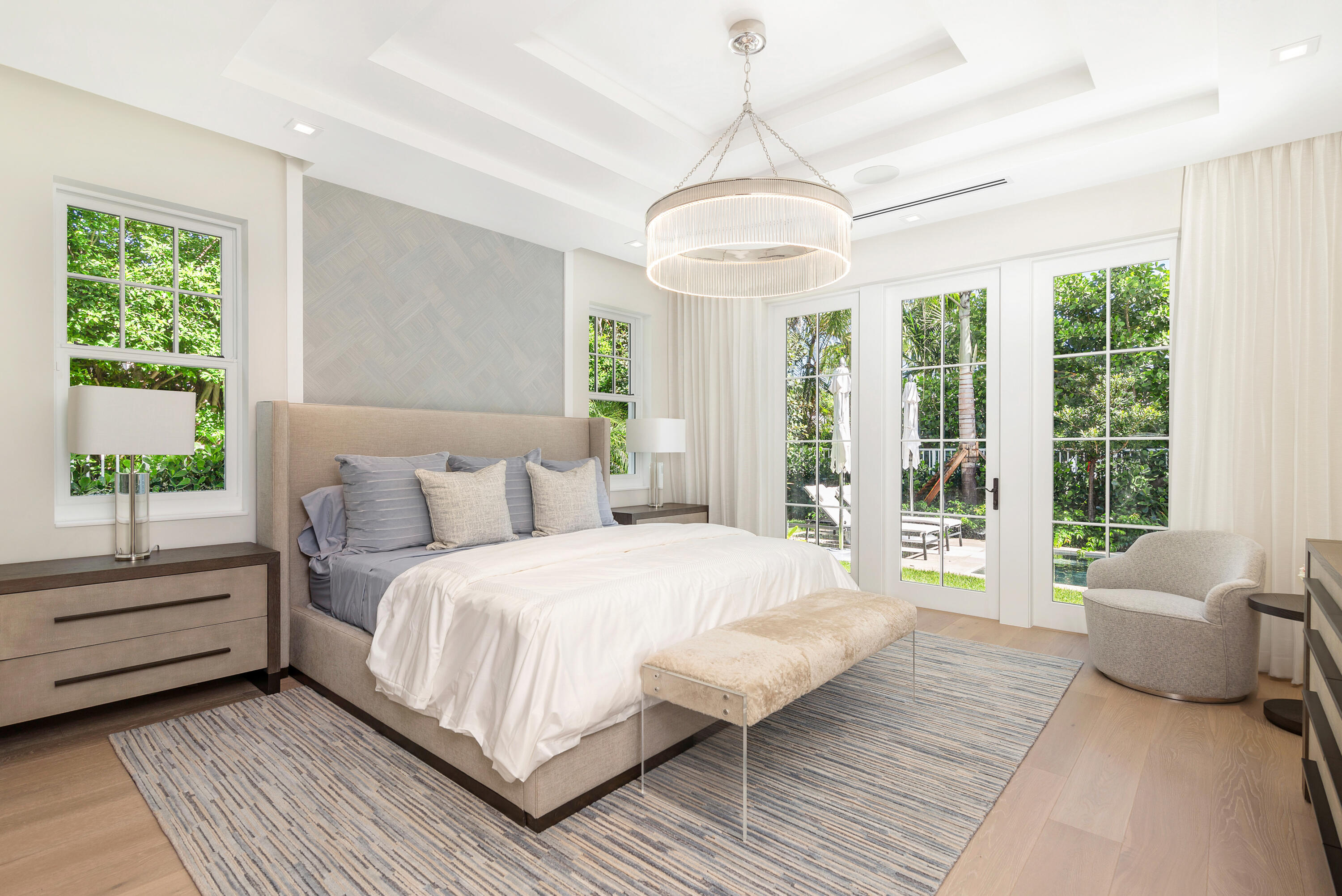 223 Monterey Road Palm Beach, FL 33480 - Photo 25 of 45 a spacious bedroom with a large bed and a chandelier