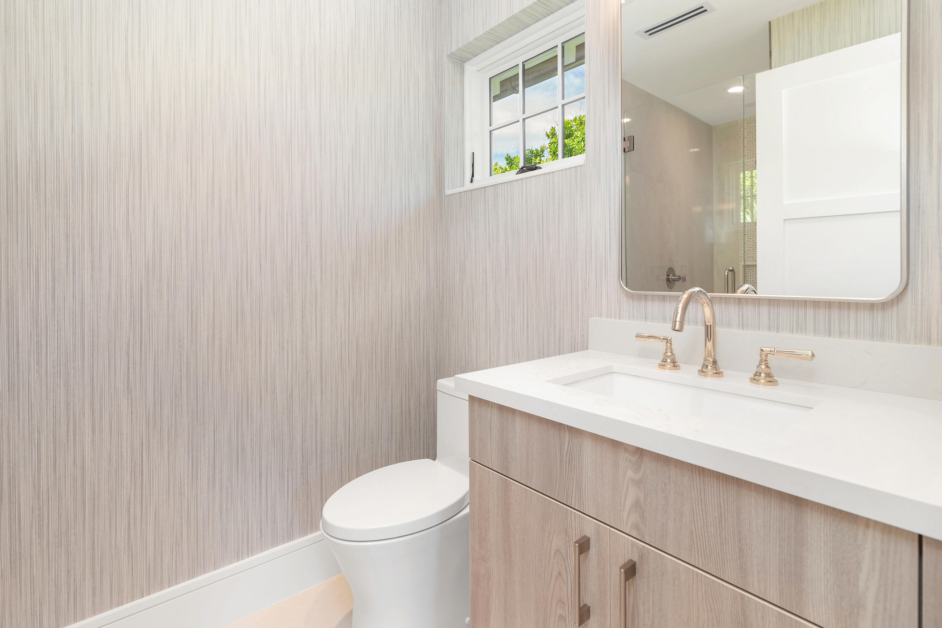 223 Monterey Road Palm Beach, FL 33480 - Photo 34 of 45 a bathroom with a sink a toilet and mirror