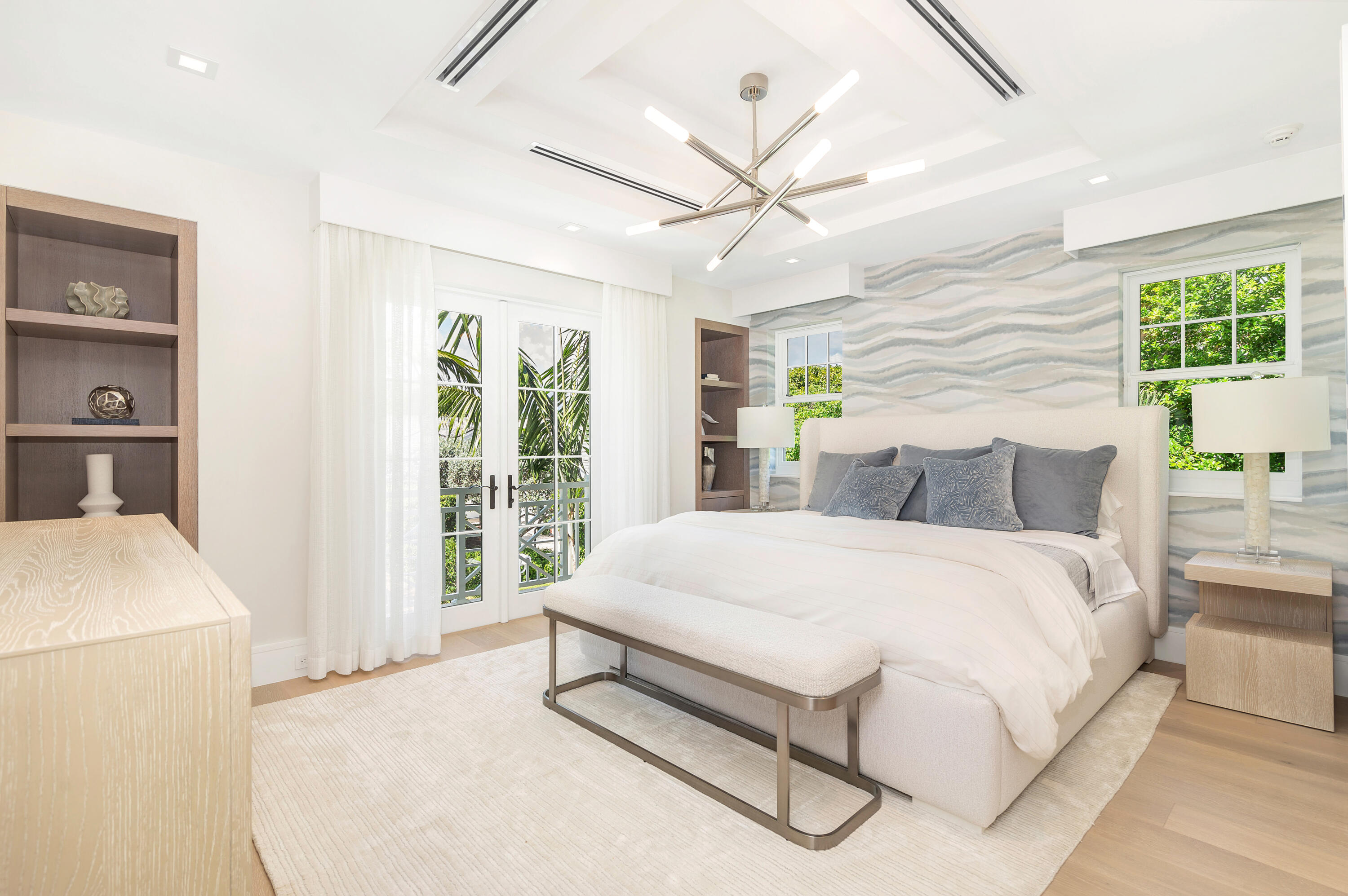 223 Monterey Road Palm Beach, FL 33480 - Photo 35 of 45 a spacious bedroom with a large bed and a chandelier