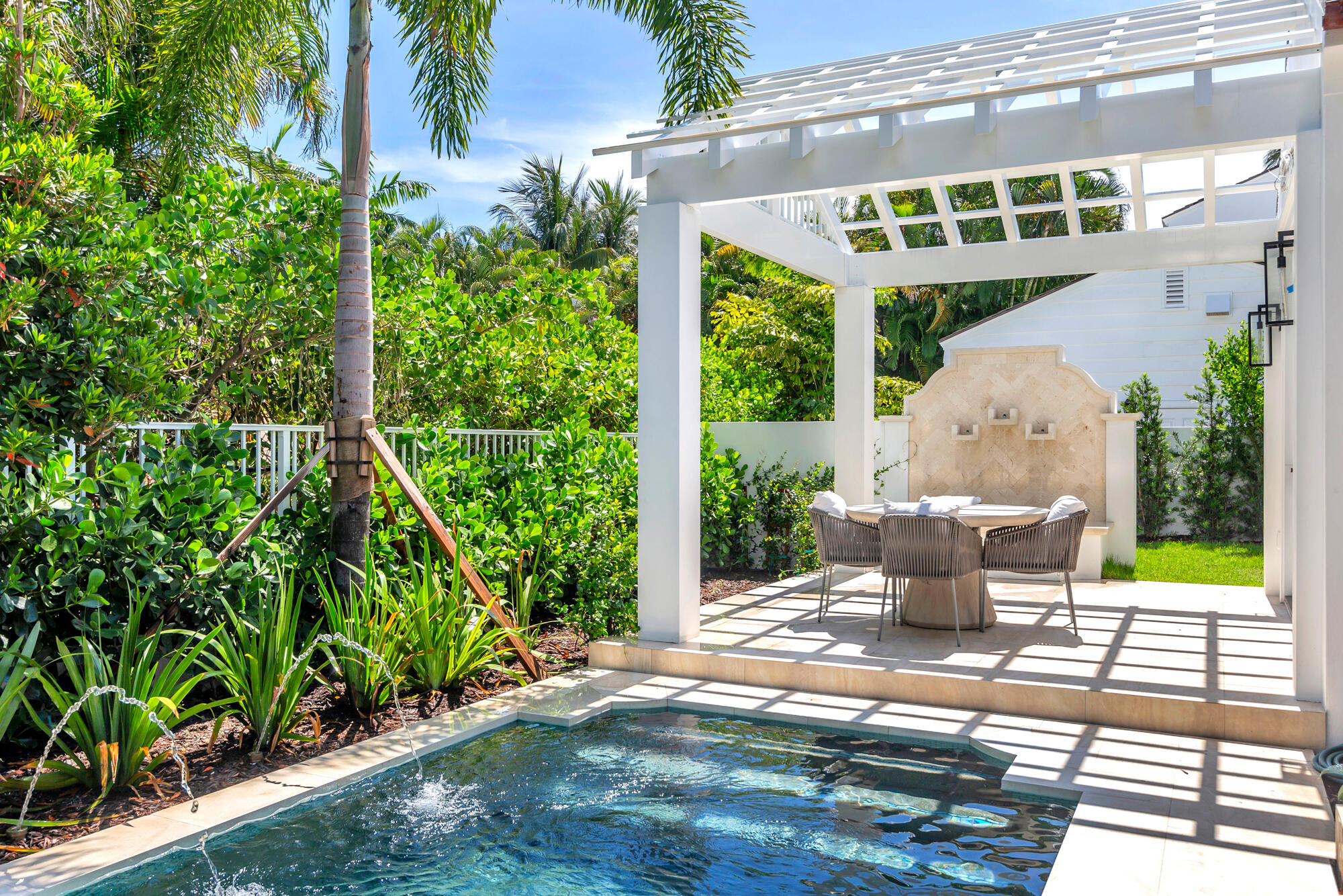 223 Monterey Road Palm Beach, FL 33480 - Photo 43 of 45 a view of a chair and tables in the patio next to a yard
