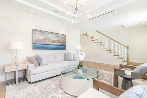 a living room with furniture and a lamp