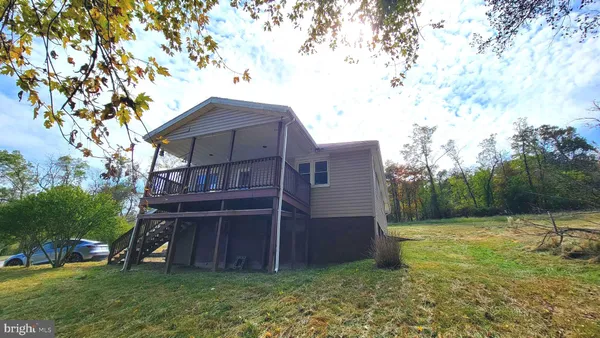 a view of backyard with barn and plants