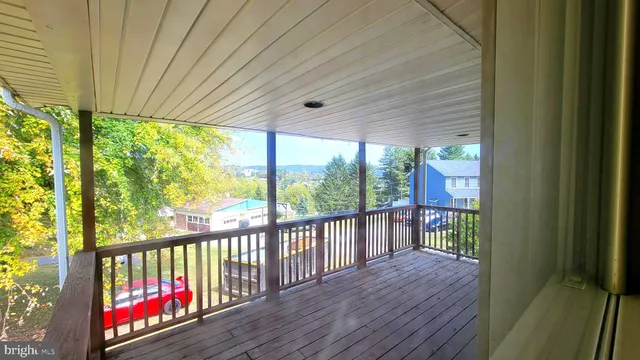 a view of a balcony with wooden floor