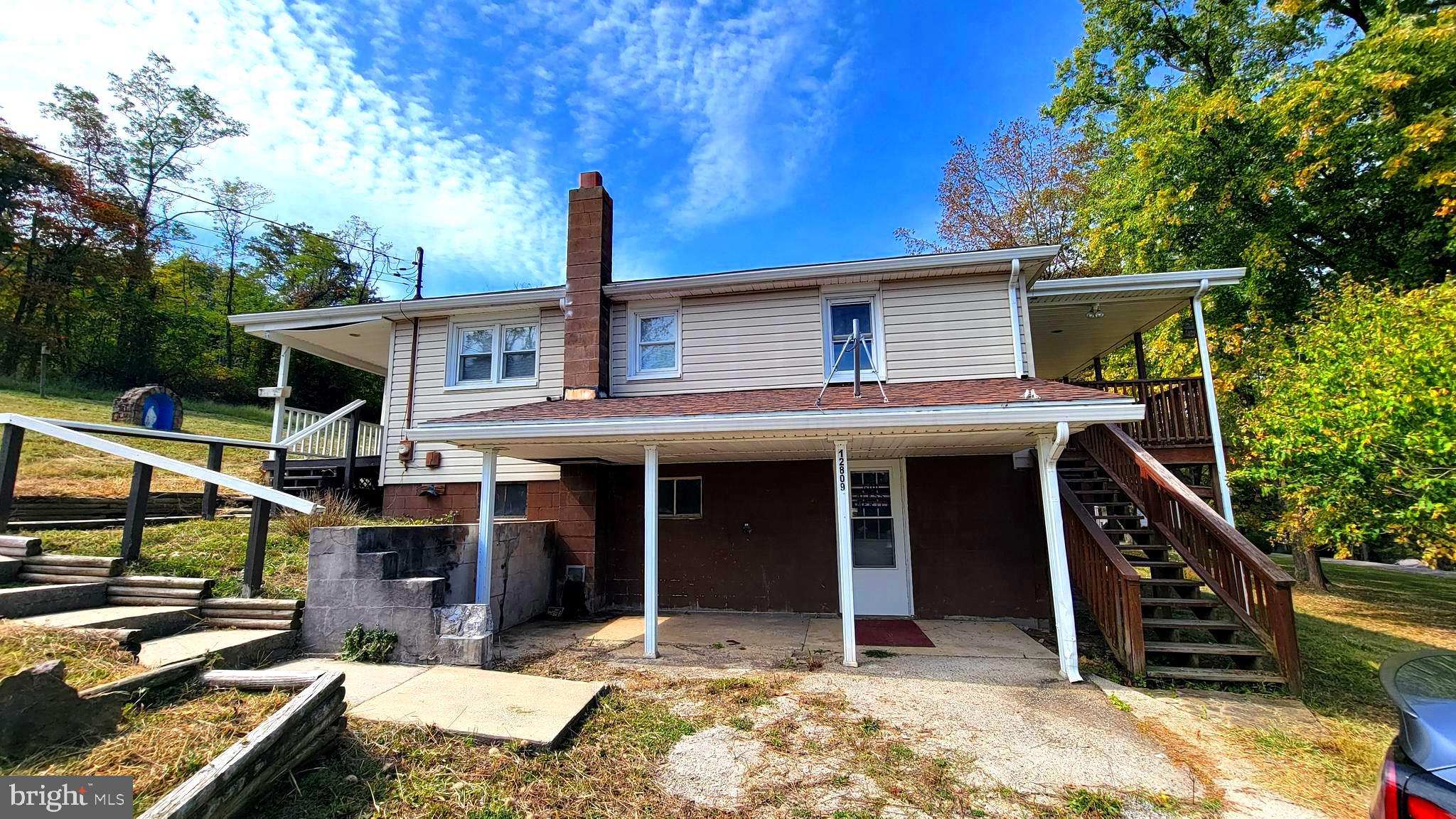 12809 Walsh Road Mount Savage, MD 21545 - Photo 2 of 30 a front view of a house with a porch