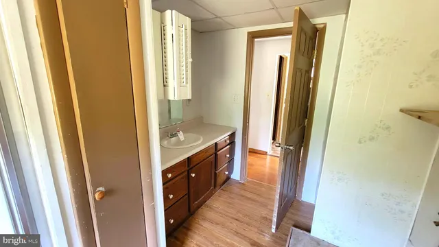 an empty room with a ceiling fan and a window