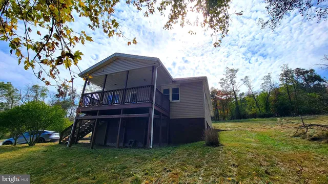 a view of backyard with wooden fence and trees