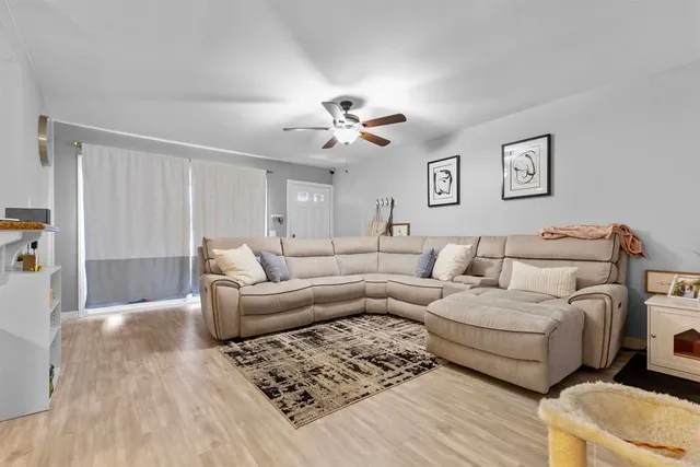 a living room with furniture and a chandelier