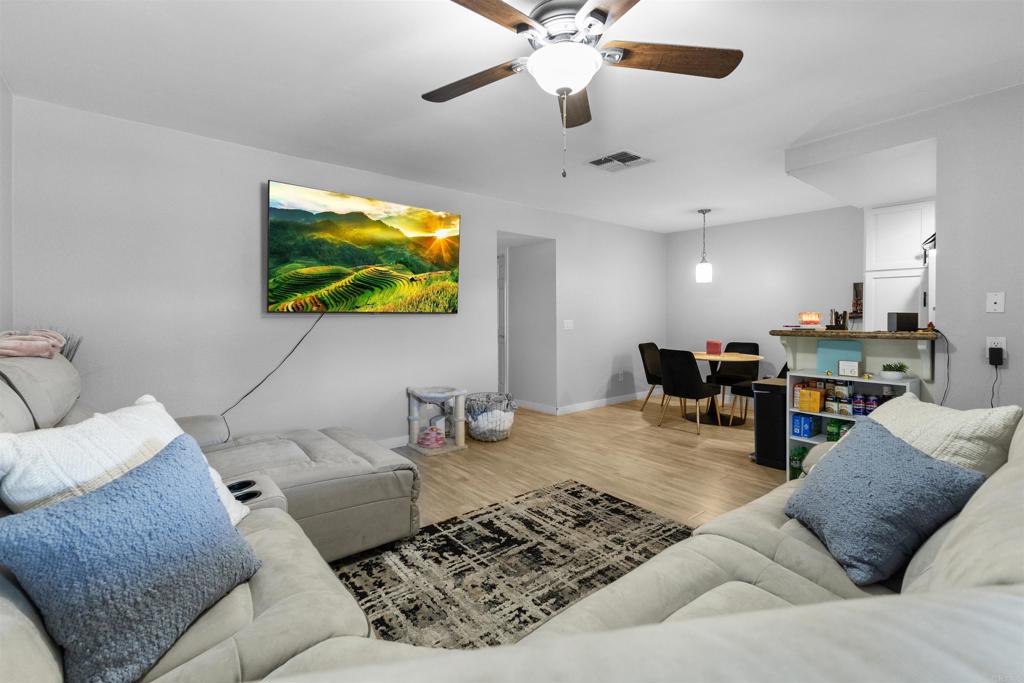 495 San Pasqual Valley Road, Unit 144 Escondido, CA 92025 - Photo 2 of 20 a living room with furniture and a flat screen tv