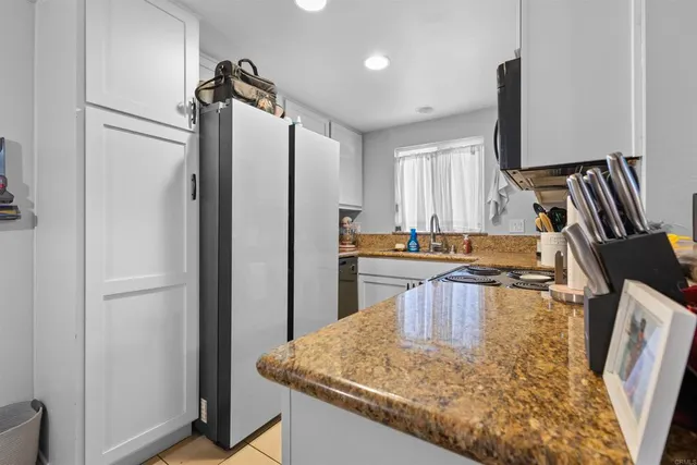 a kitchen with kitchen island a counter top space appliances and cabinets