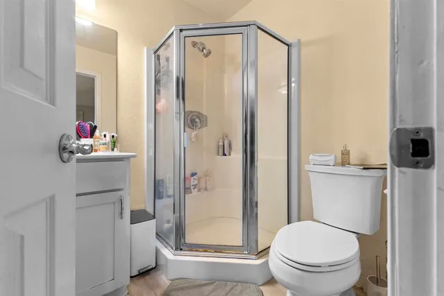 a bathroom with a shower a toilet and a sink