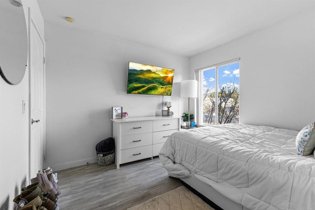 495 San Pasqual Valley Road, Unit 144 Escondido, CA 92025 - Photo 9 of 20 a bedroom with a bed and a flat screen tv