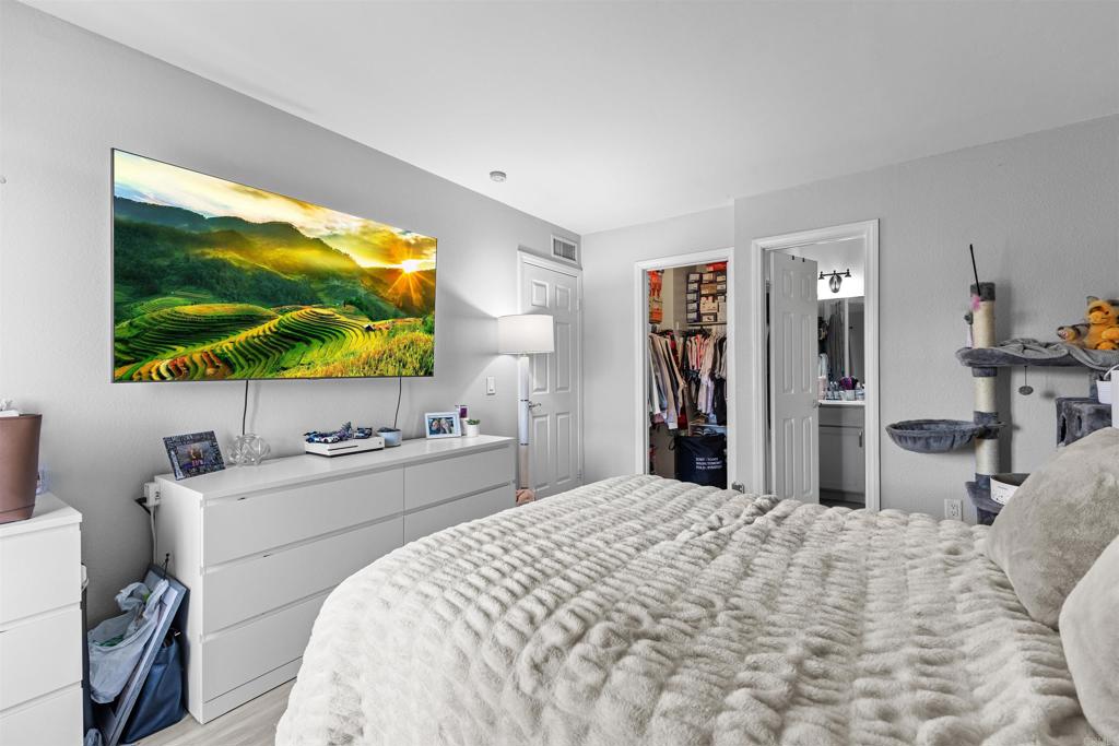 495 San Pasqual Valley Road, Unit 144 Escondido, CA 92025 - Photo 10 of 20 a bedroom with a bed and a flat screen tv