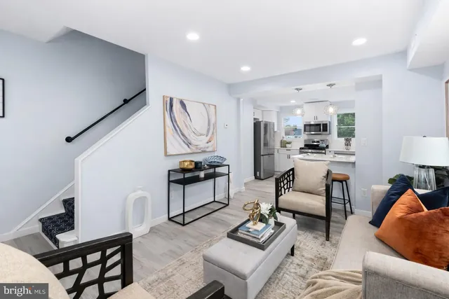 a living room with furniture and kitchen view