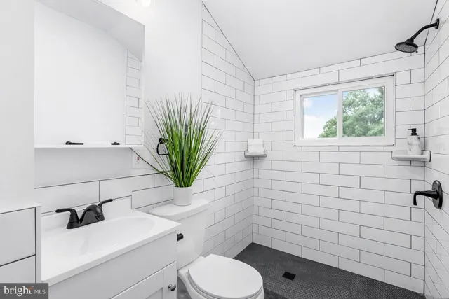 a bathroom with a sink a toilet and tub