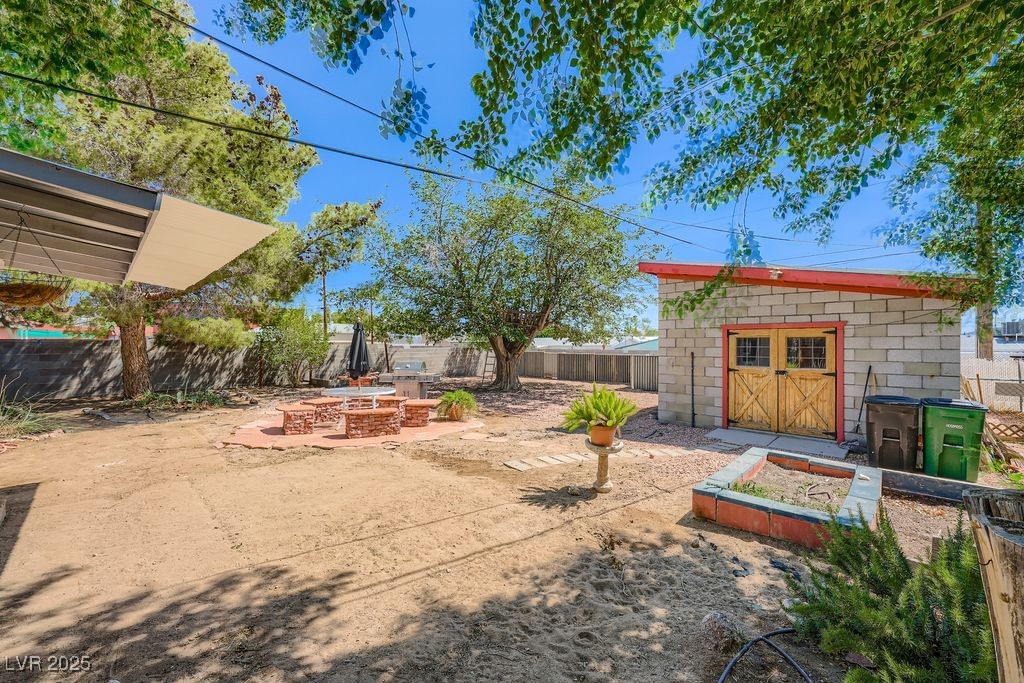 573 7th Street Boulder City, NV 89005 - Photo 22 of 25 Front of garage and garden areas. Room for RV and gate to alley opens for access