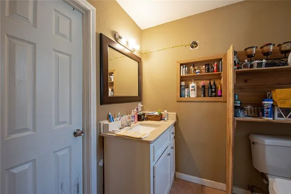 a bathroom with a sink vanity and a mirror