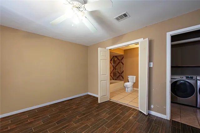 a view of a livingroom with wooden floor and a ceiling fan