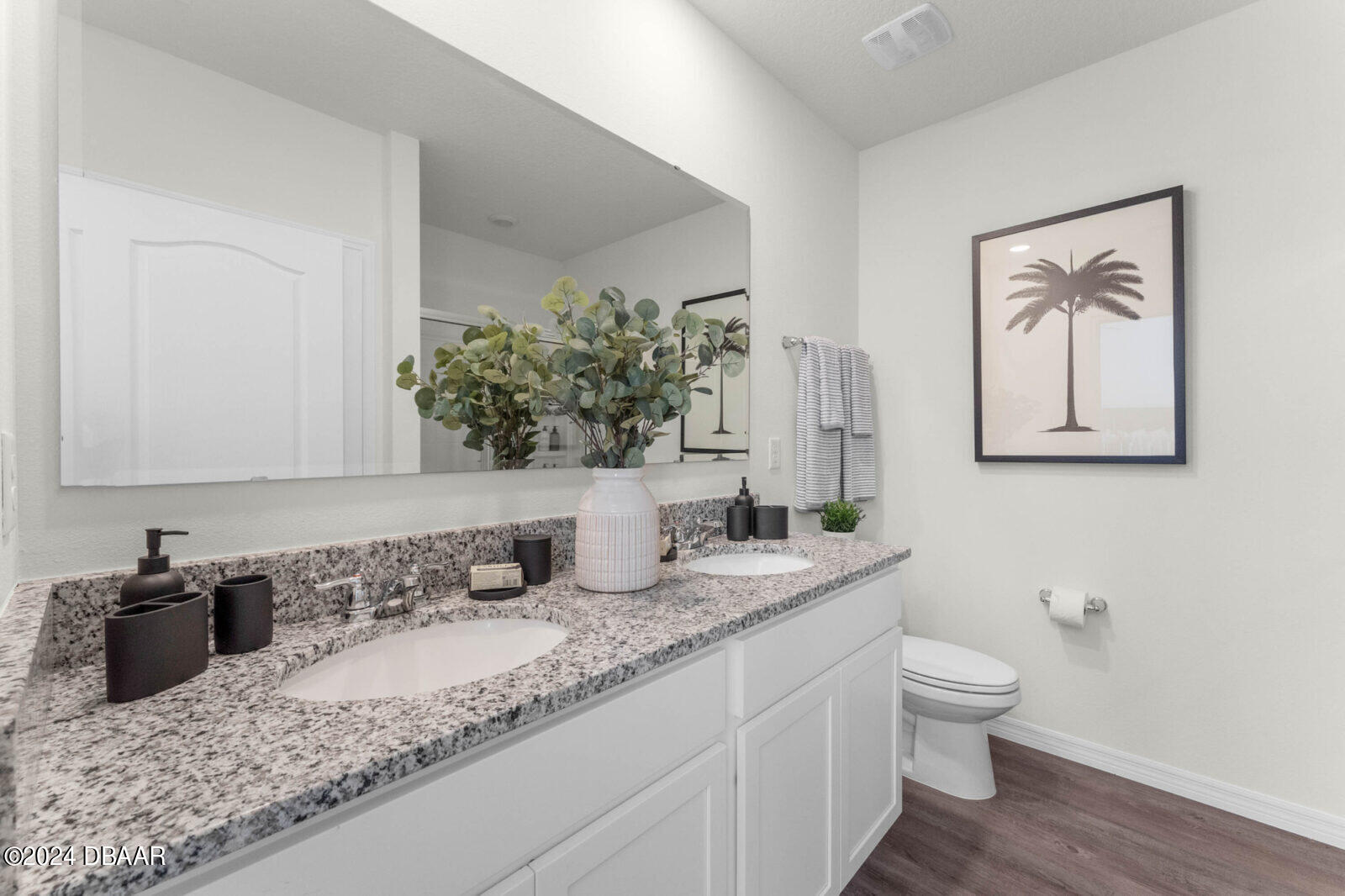 44 Center Grande Road Ormond Beach, FL 32174 - Photo 14 of 20 a bathroom with a granite countertop sink and a toilet