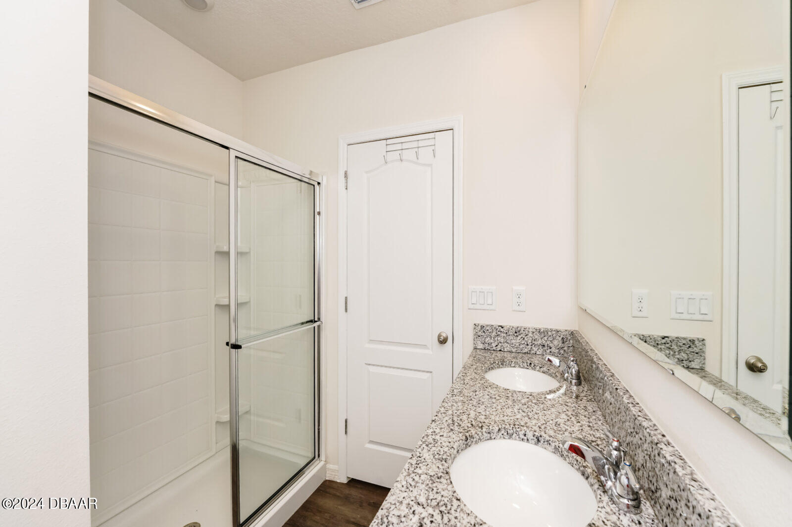 44 Center Grande Road Ormond Beach, FL 32174 - Photo 6 of 20 a bathroom with a granite countertop sink a mirror and a shower