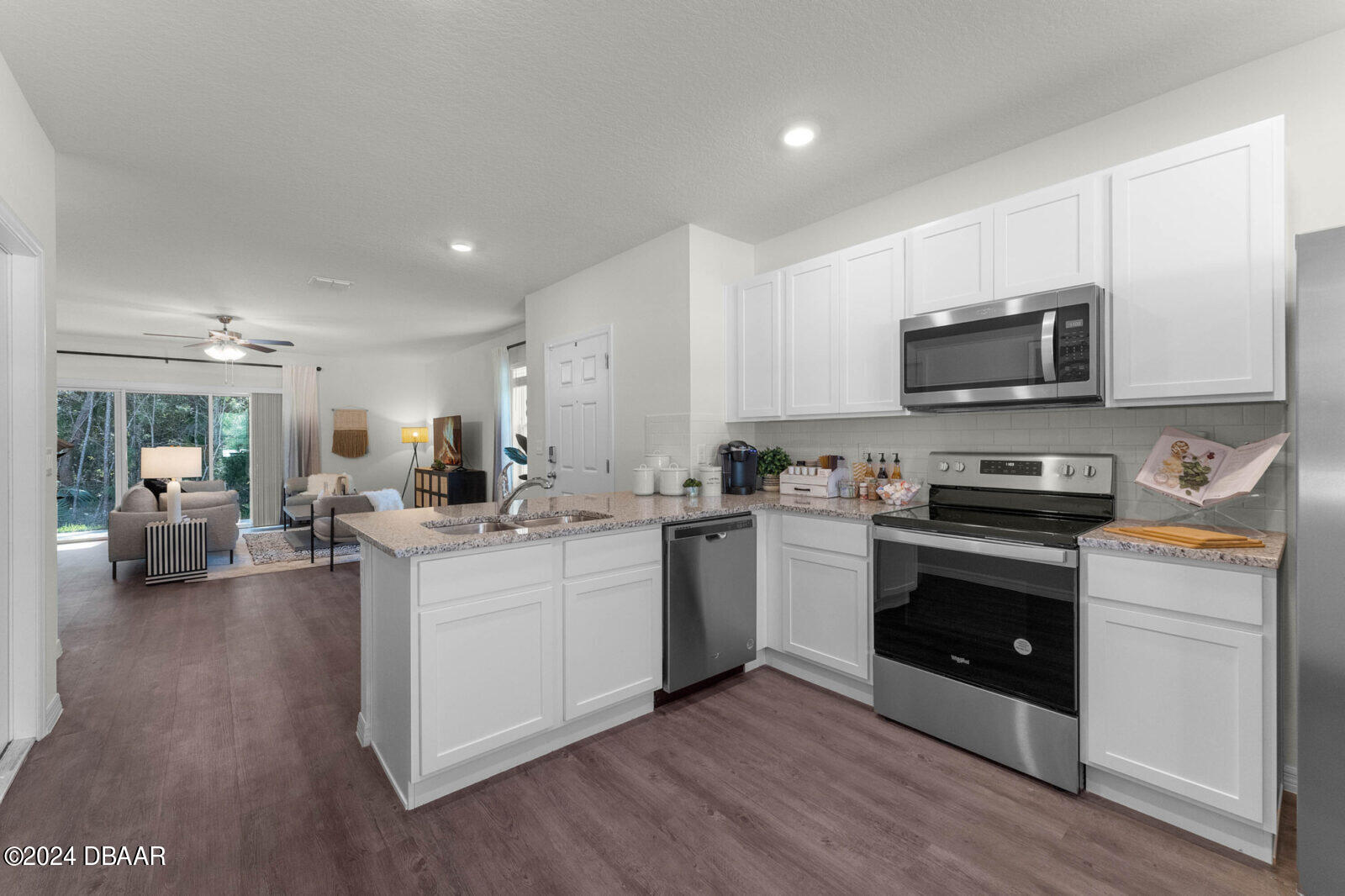 44 Center Grande Road Ormond Beach, FL 32174 - Photo 10 of 20 a kitchen with sink a stove and cabinets