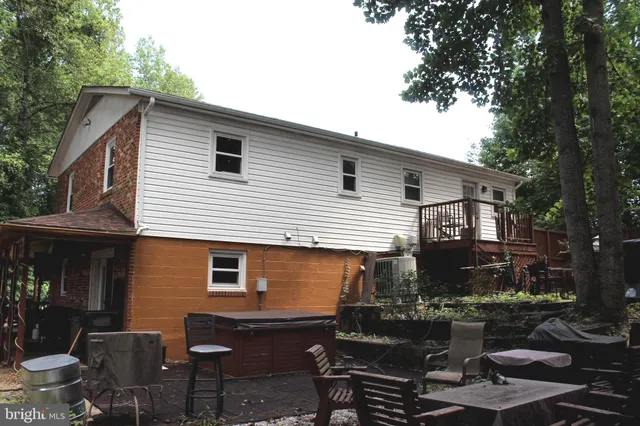 a view of backyard of house with outdoor seating