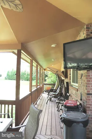 a view of a dining room with furniture a chandelier and wooden floor