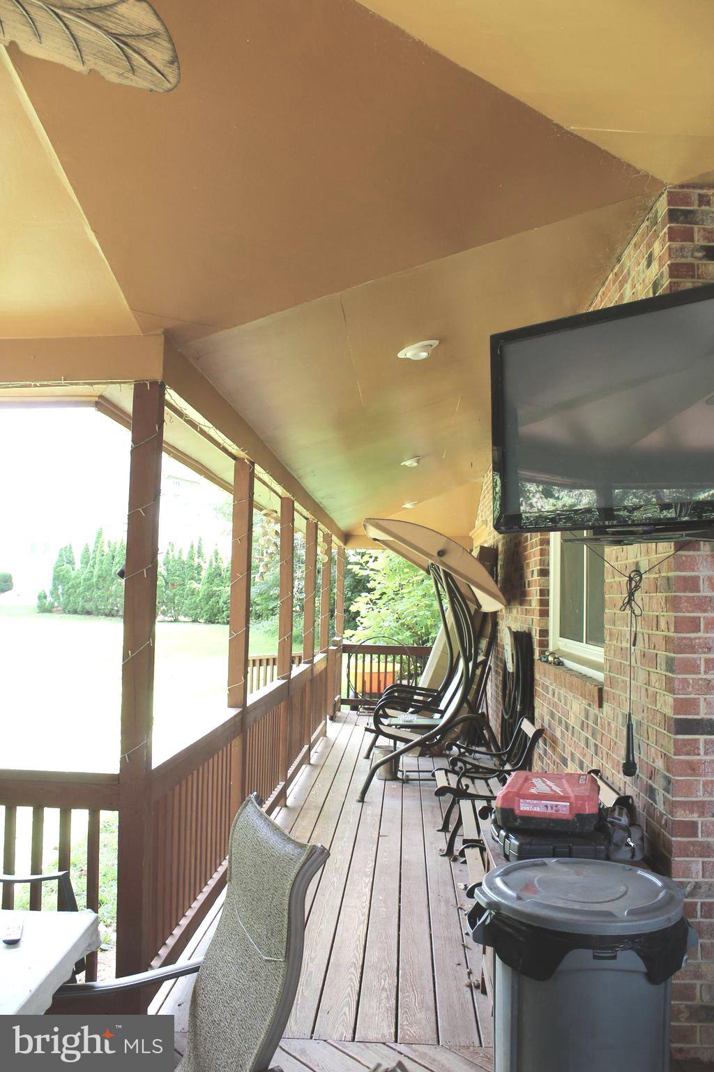 15090 Jonah Cove Place Woodbridge, VA 22193 - Photo 17 of 42 a view of a dining room with furniture a chandelier and wooden floor