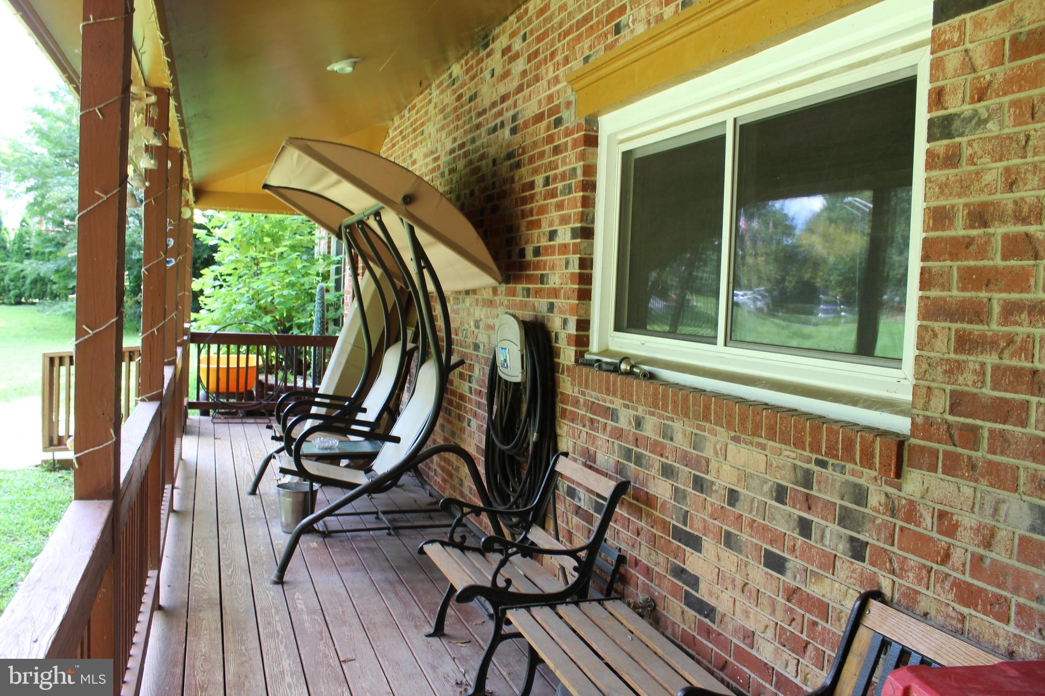 15090 Jonah Cove Place Woodbridge, VA 22193 - Photo 18 of 42 a view of a balcony with chairs and wooden floor
