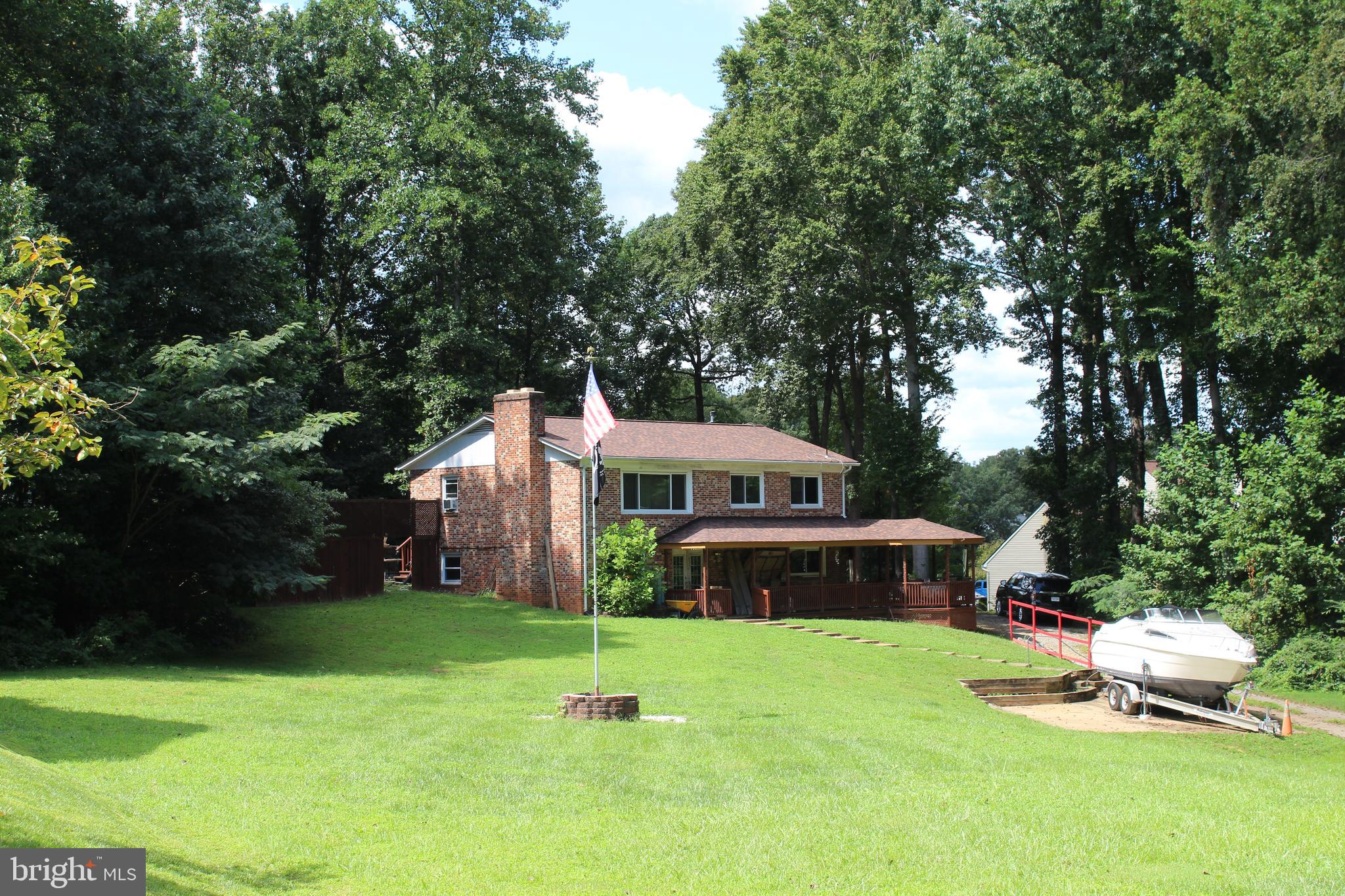 15090 Jonah Cove Place Woodbridge, VA 22193 - Photo 2 of 42 a front view of a house with a garden and trees
