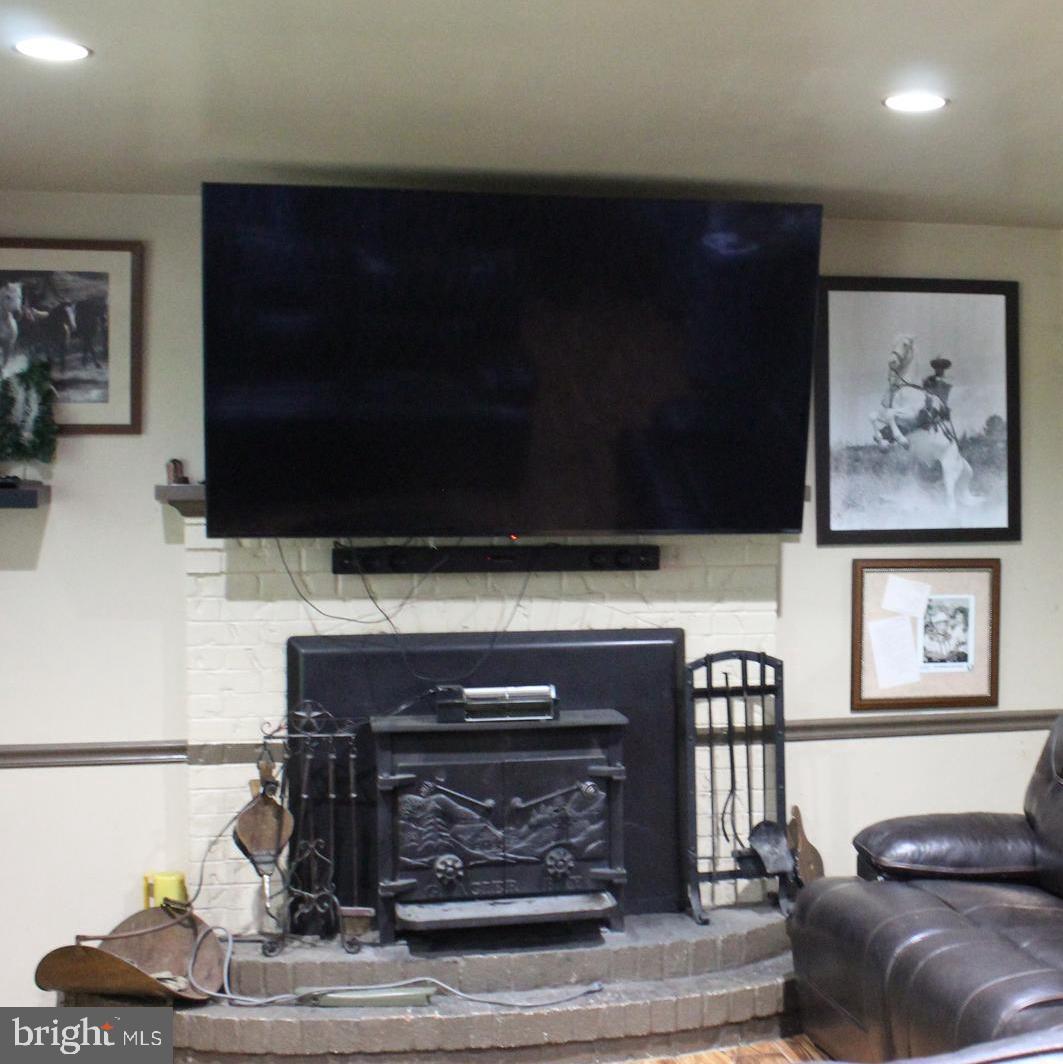 15090 Jonah Cove Place Woodbridge, VA 22193 - Photo 24 of 42 a living room with a fireplace and a flat screen tv