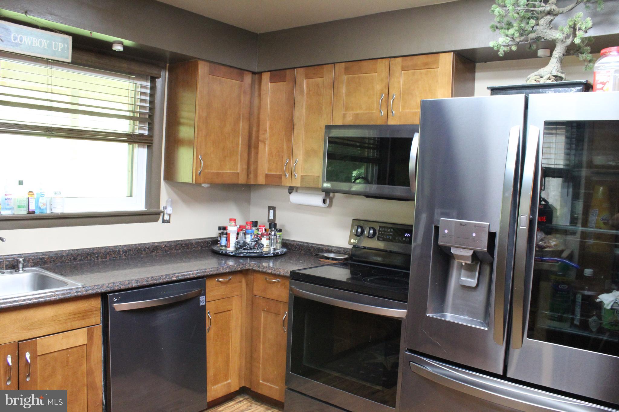 15090 Jonah Cove Place Woodbridge, VA 22193 - Photo 31 of 42 a kitchen with a refrigerator and a sink
