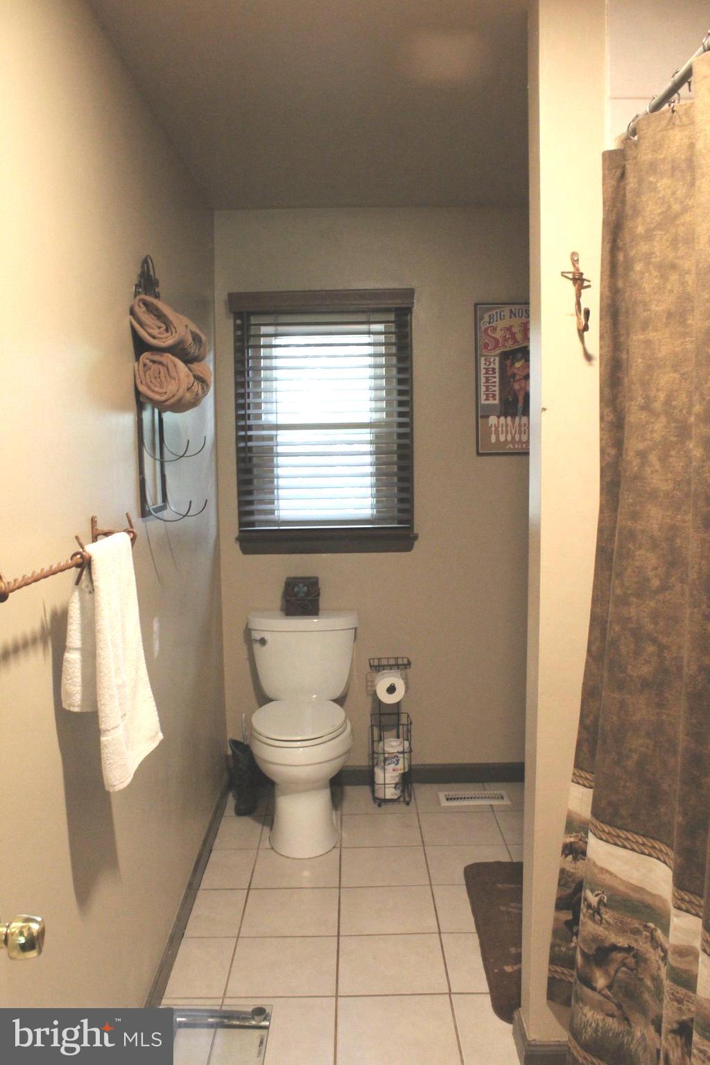 15090 Jonah Cove Place Woodbridge, VA 22193 - Photo 34 of 42 a bathroom with a toilet a sink and a shower