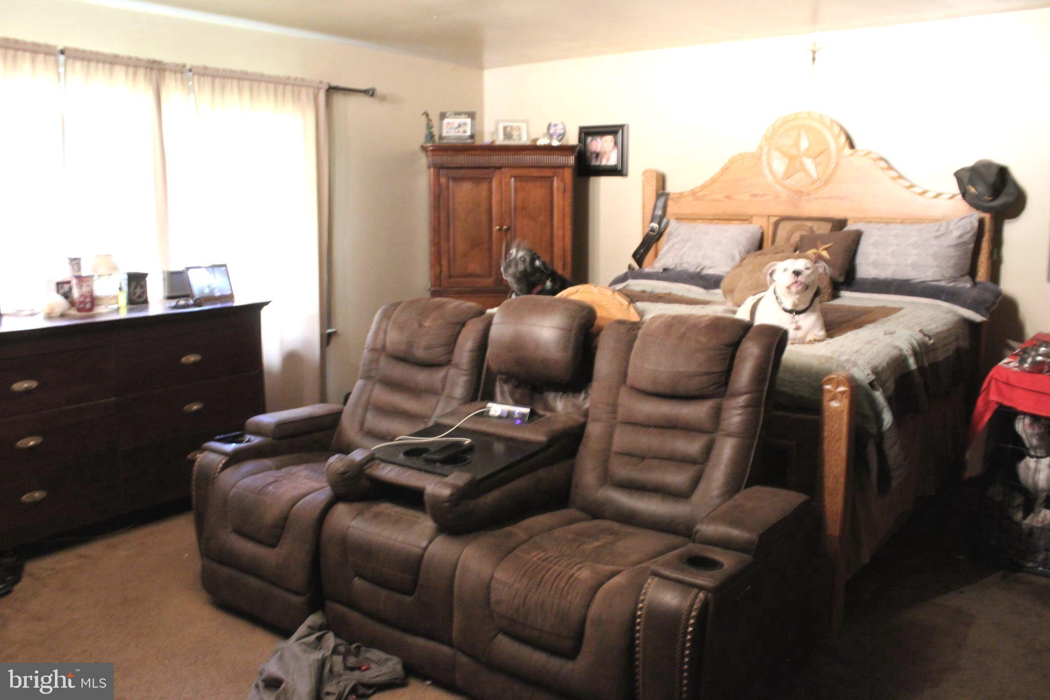 15090 Jonah Cove Place Woodbridge, VA 22193 - Photo 36 of 42 a bed room with a bed and a chair