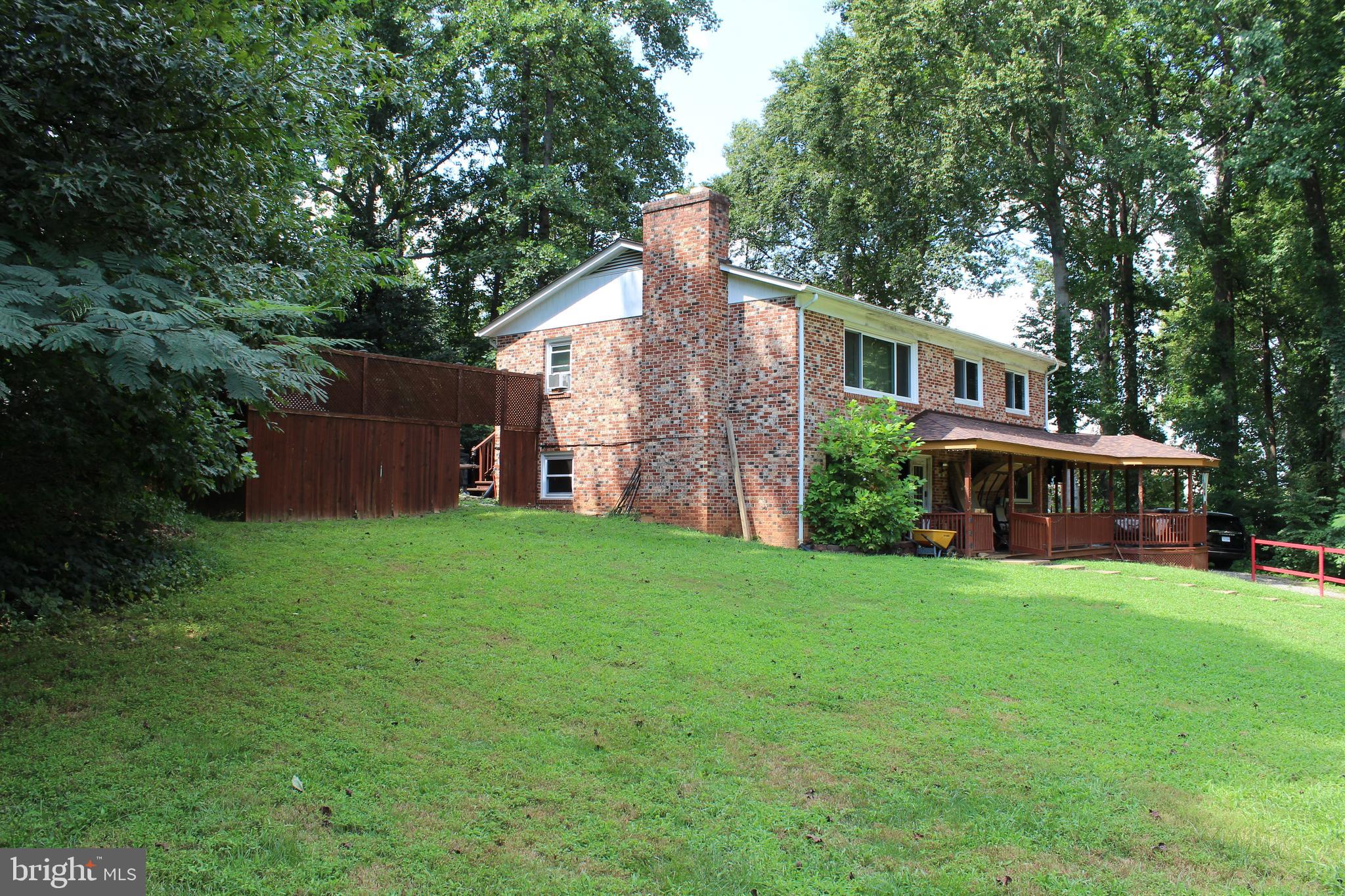 15090 Jonah Cove Place Woodbridge, VA 22193 - Photo 7 of 42 front view of a house with a yard and trees