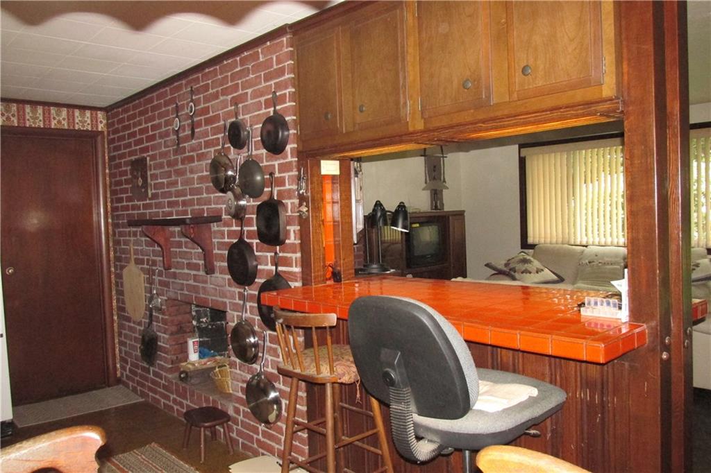 231 Mingo Church Road Finleyville, PA 15332 - Photo 9 of 20 kitchen, another view, showing the back of the fire place, a pass thru from kitchen to living room, door ahead leads to the garage