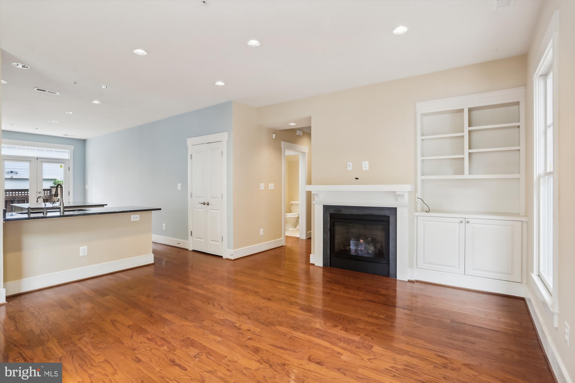 9539 Ament Street Silver Spring, MD 20910 - Photo 11 of 40 a view of a kitchen and a fireplace wooden floor and kitchen