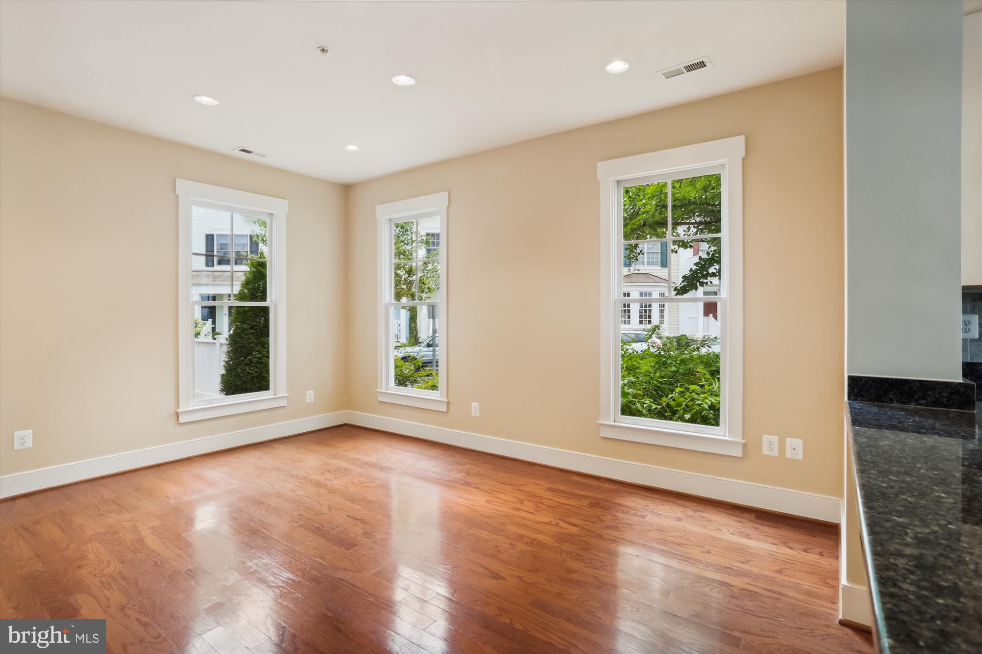 9539 Ament Street Silver Spring, MD 20910 - Photo 12 of 40 a view of an empty room with wooden floor and a window