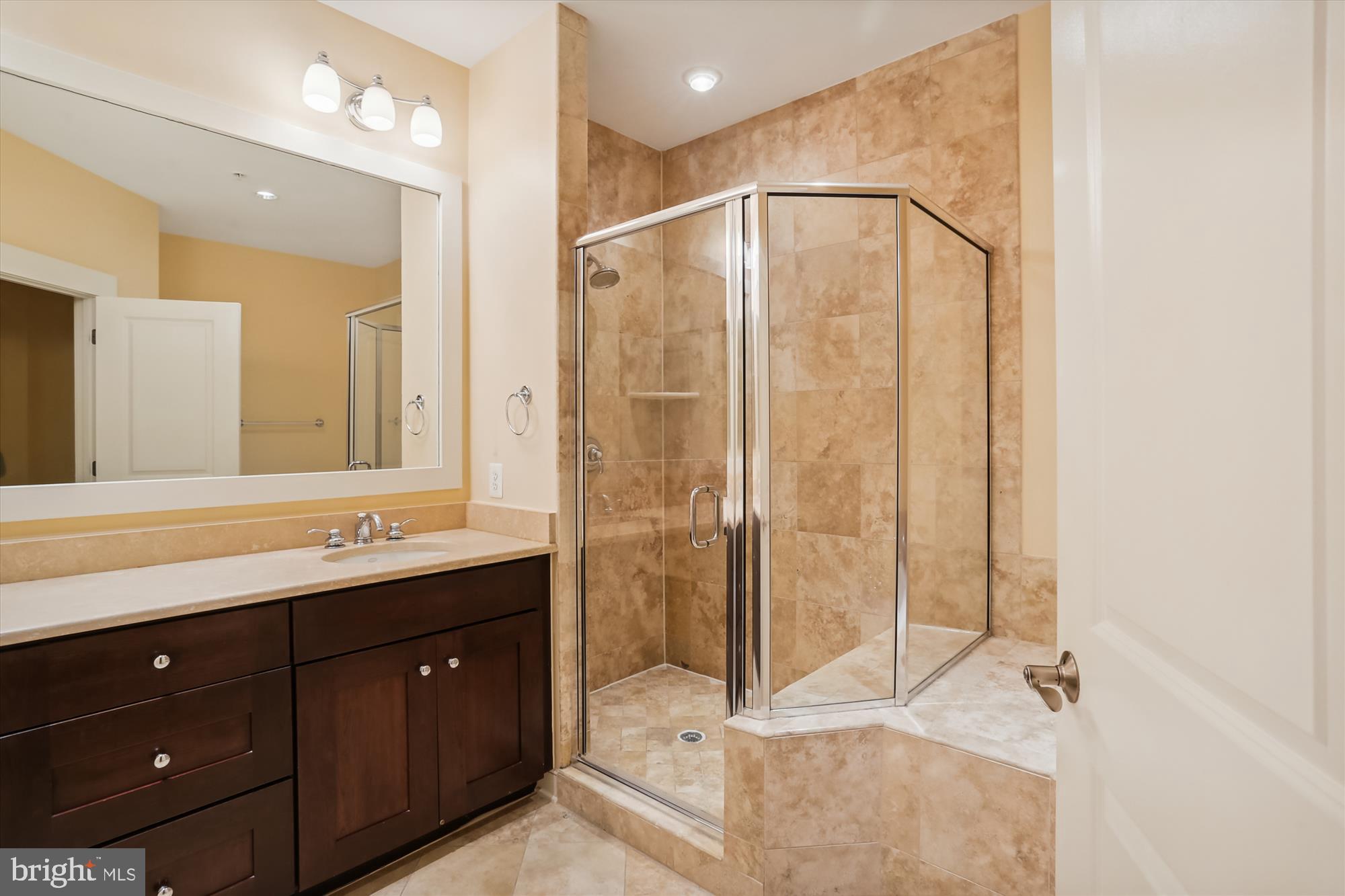 9539 Ament Street Silver Spring, MD 20910 - Photo 30 of 40 a bathroom with a double vanity sink and mirror with shower