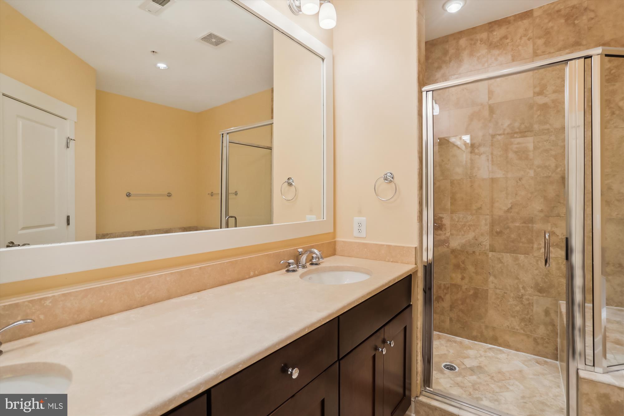 9539 Ament Street Silver Spring, MD 20910 - Photo 32 of 40 a bathroom with a shower sink and mirror