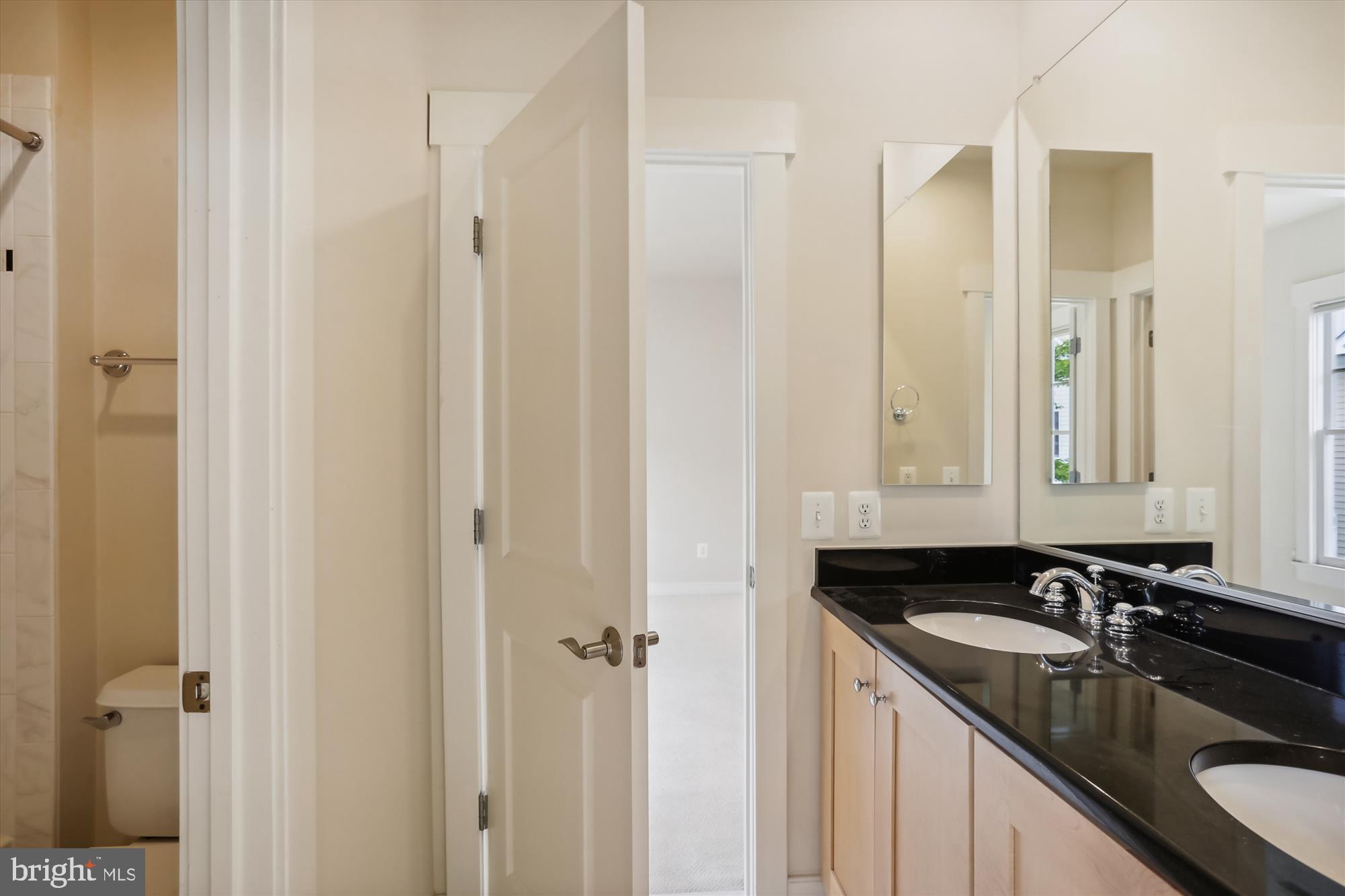 9539 Ament Street Silver Spring, MD 20910 - Photo 36 of 40 a bathroom with a granite countertop sink and a mirror