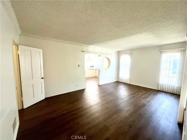 a view of a livingroom with wooden floor and window
