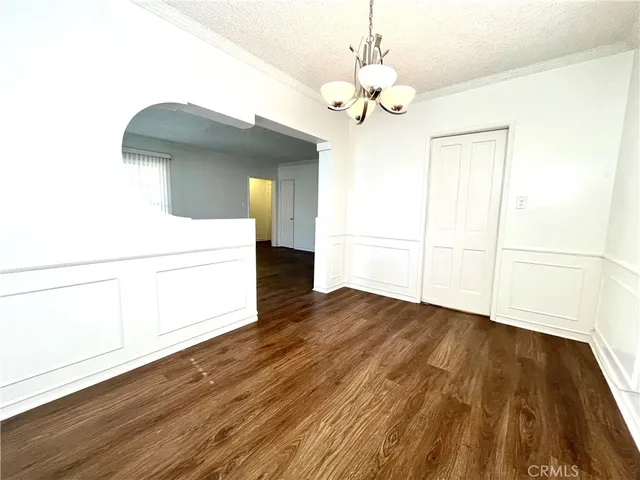 a view of a room with wooden floor and cabinet
