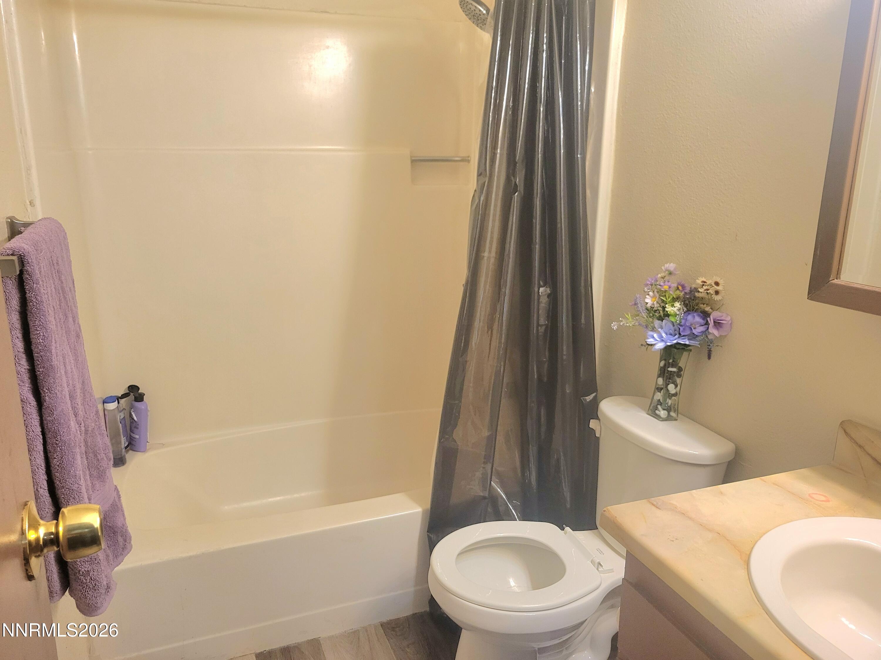 1404 East 9th Street, Unit 3 Reno, NV 89512 - Photo 27 of 29 a bathroom with a sink a toilet and shower