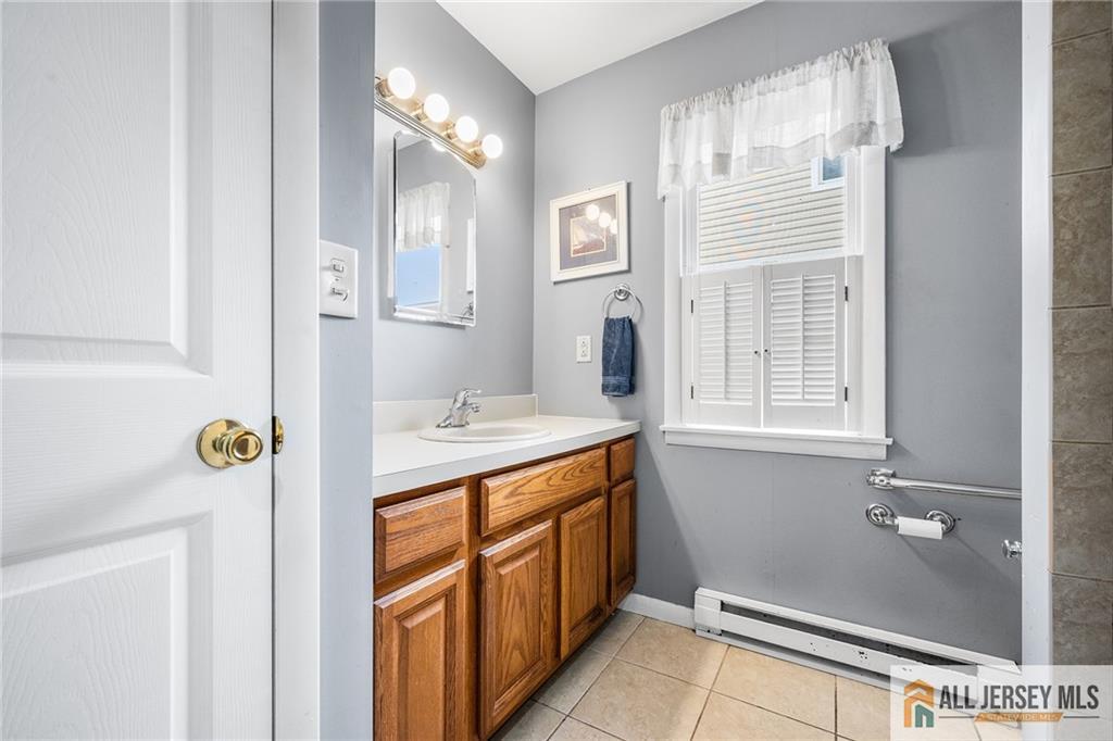 67 Drake Place Colonia, NJ 07067 - Photo 26 of 31 a bathroom with a sink and a mirror