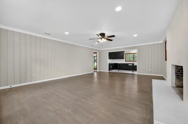 a view of an empty room with a fireplace
