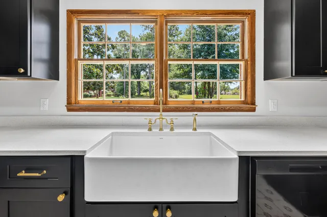 a bathroom with a sink and next to a window